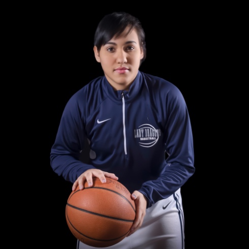 graduating high school girl posing for senior pictures with basketball