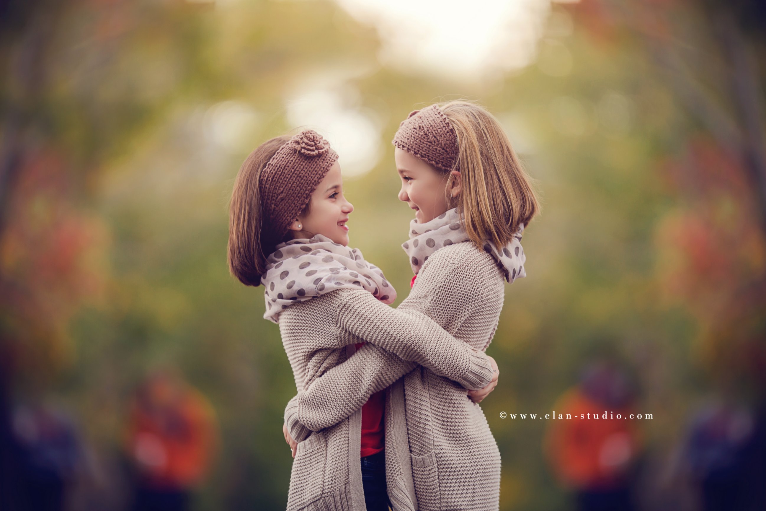 sisters embracing in fall