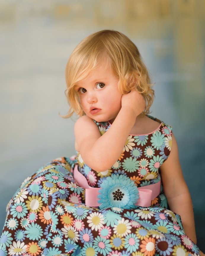 Adorable toddler in pastel floral print dress portrait