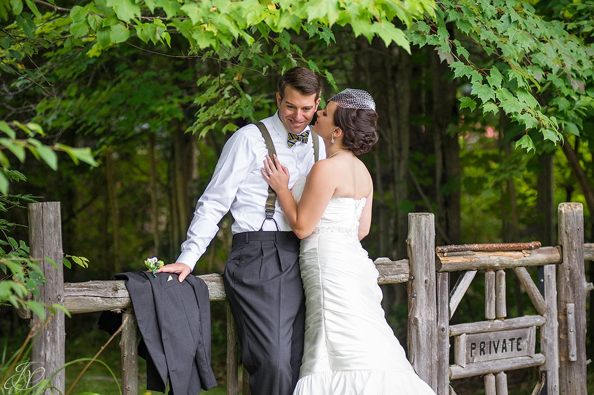 bride whispers into the groom's ear