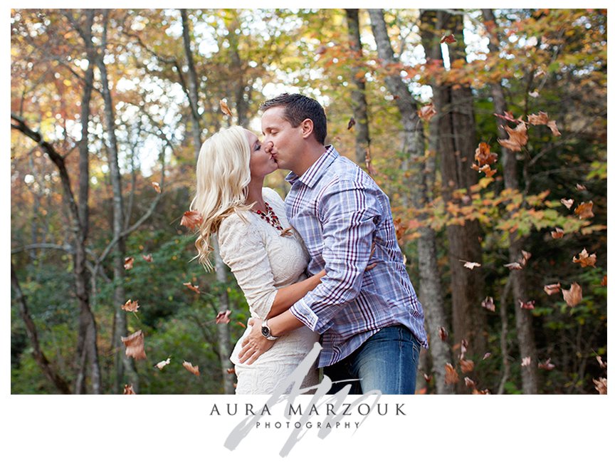 Couple play in the autumn leaves at their Pisgah National Forest autumn engagement session. © Aura Marzouk Photography, Greensboro Wedding Photographer