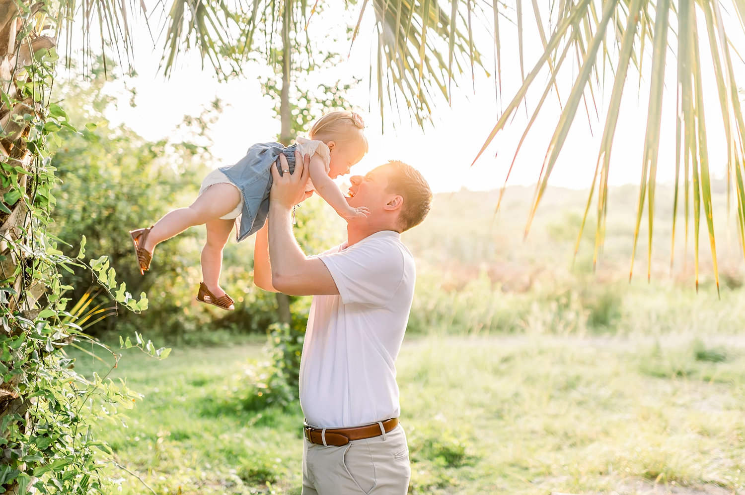 golden hour, setting sun in Florida, dad holding up baby daughter, Rya Duncklee Photography, Gainesville baby photographer