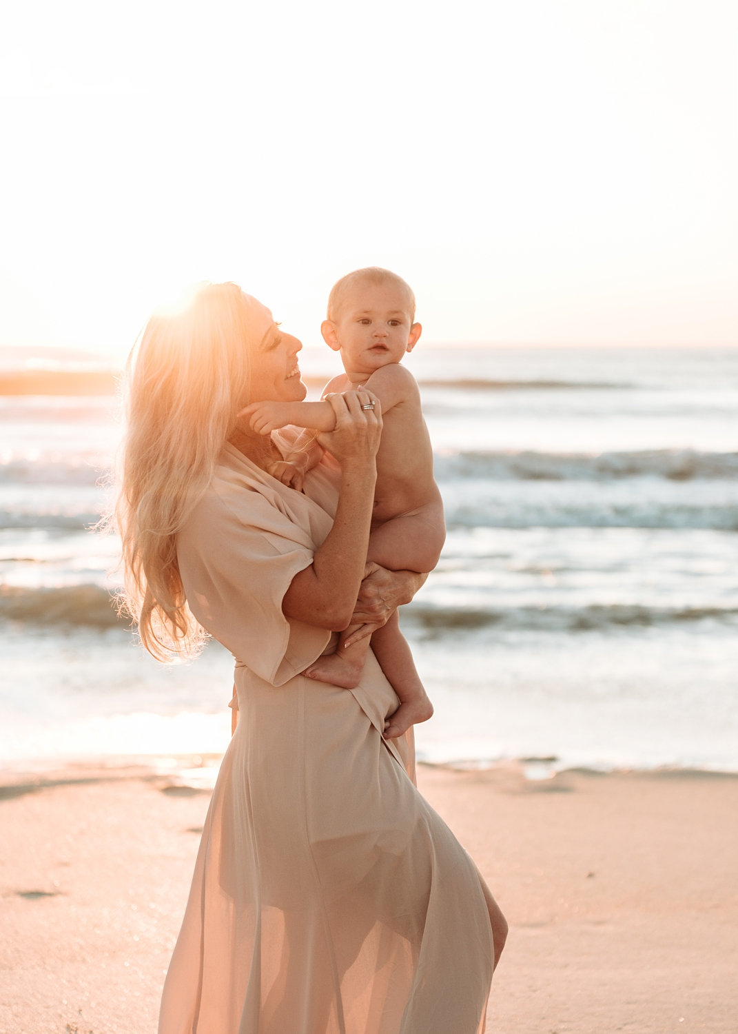 mother with blonde hair, sheer dress, coastal portrait session, Rya Duncklee