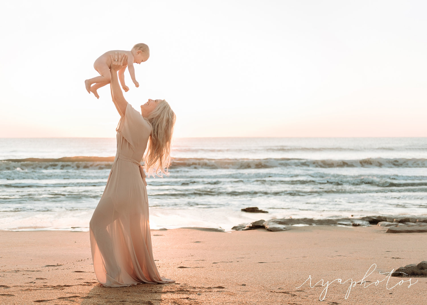 blonde mom lifting up baby boy, Atlantic Ocean, Florida coast, Rya Duncklee