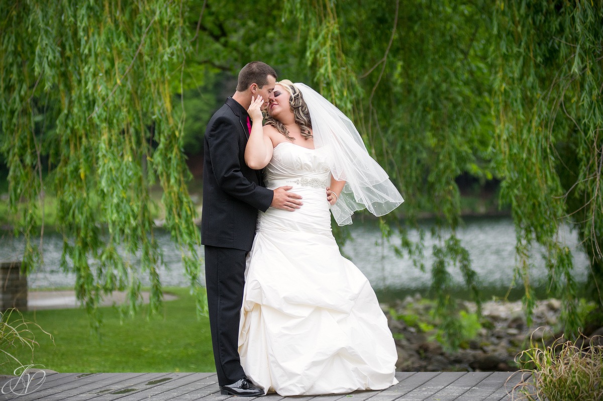 intimate moment on bridge with bride and groom