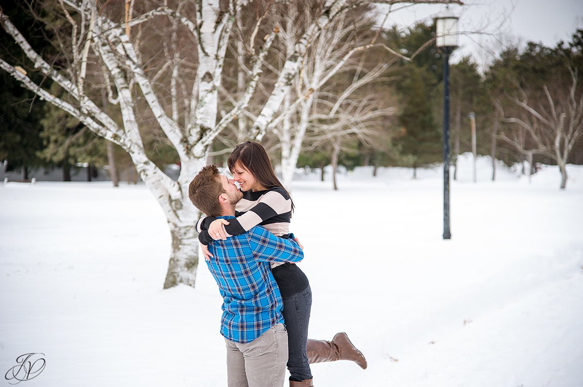 photo of guy picking up his fiance in the snow