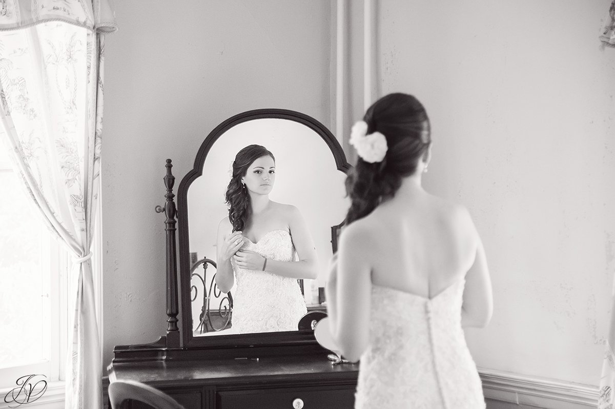beautiful image of bride looking in mirror