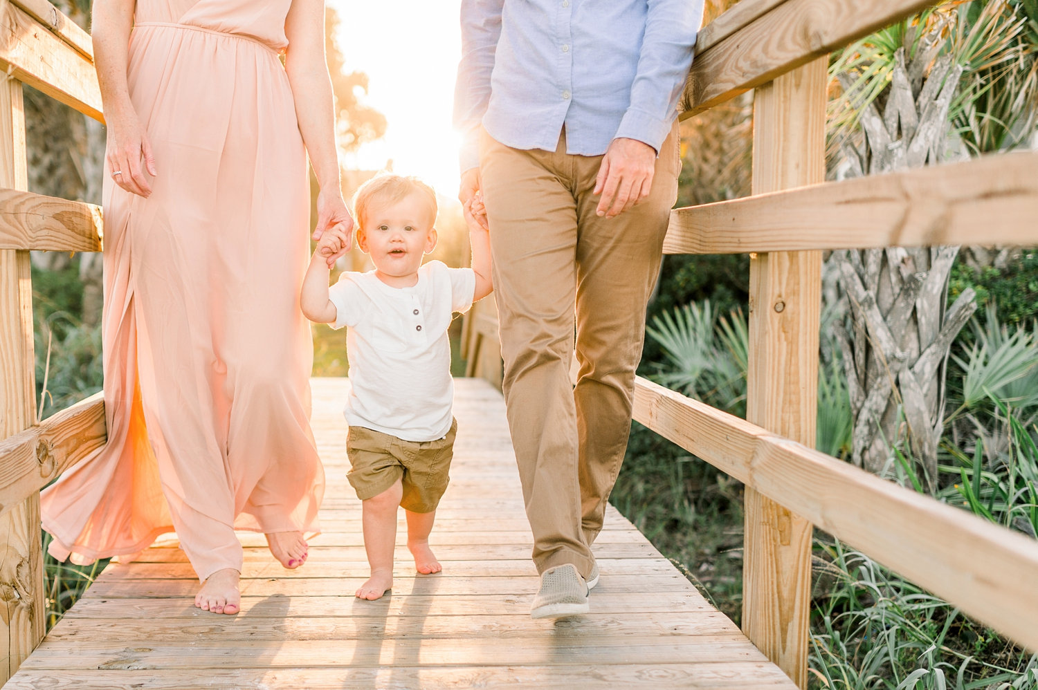 parents walking on Florida boardwalk with little boy, Ponte Vedra Beach, Rya Duncklee