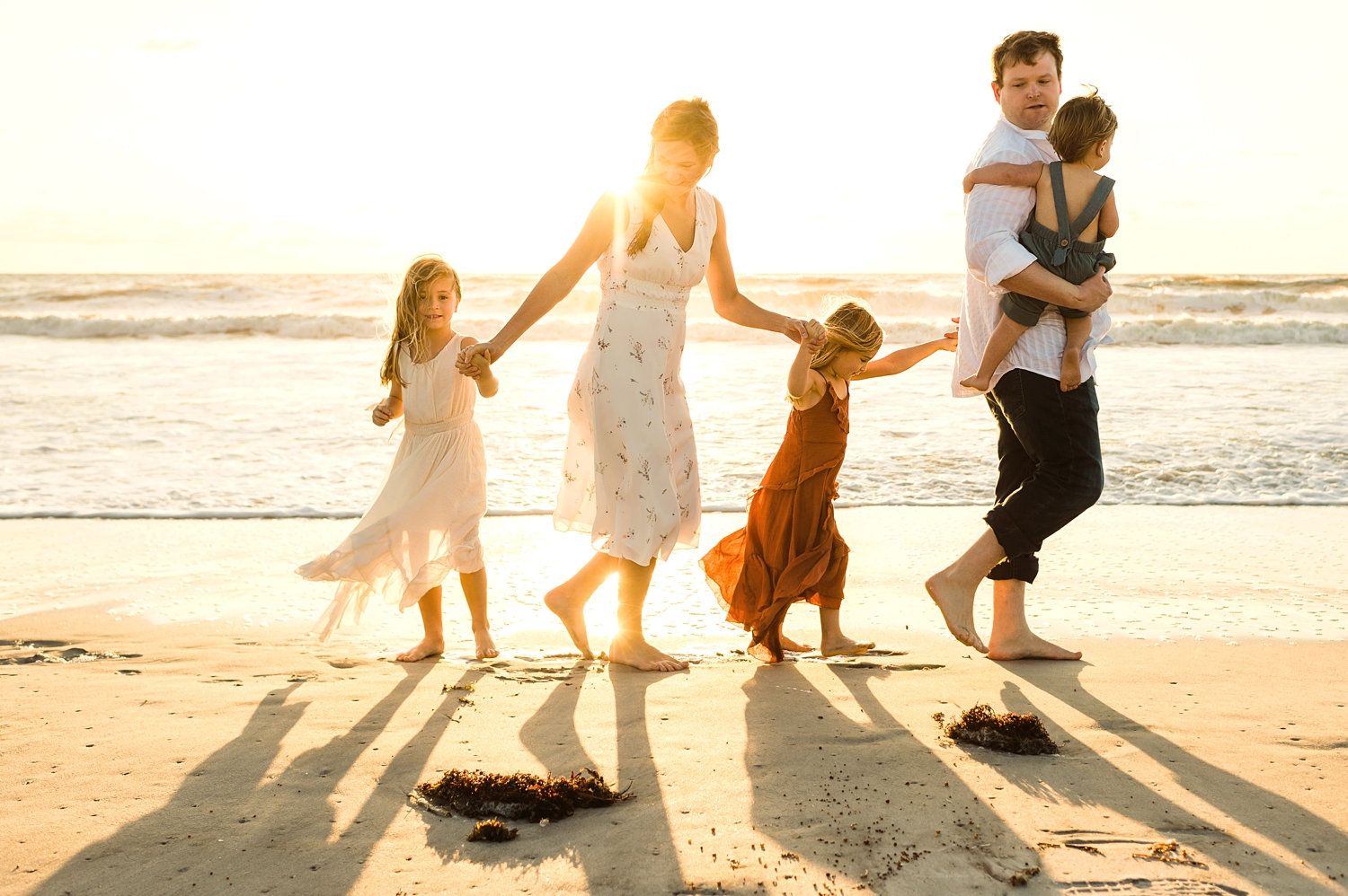 family walking hand in hand on a beach, Amelia Island, Florida, Ryaphotos