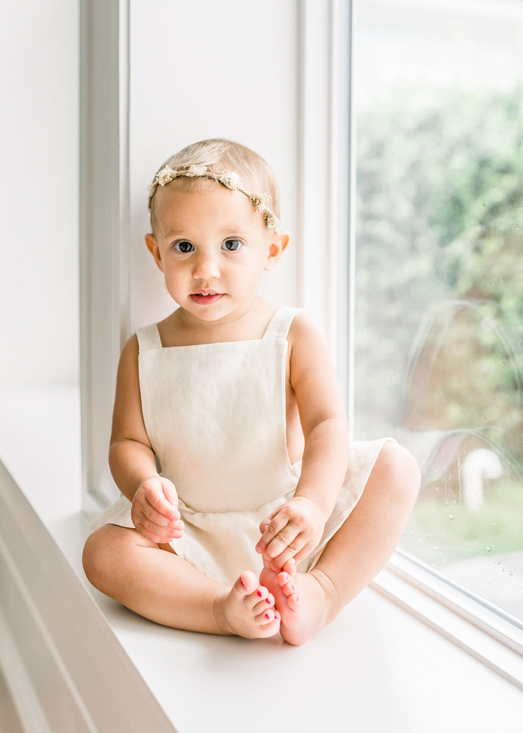 15 month old girl with painted toenails, window portrait, Ryaphotos