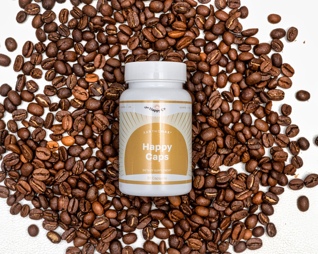 Bottle of dietary supplement surrounded by roasted coffee beans.