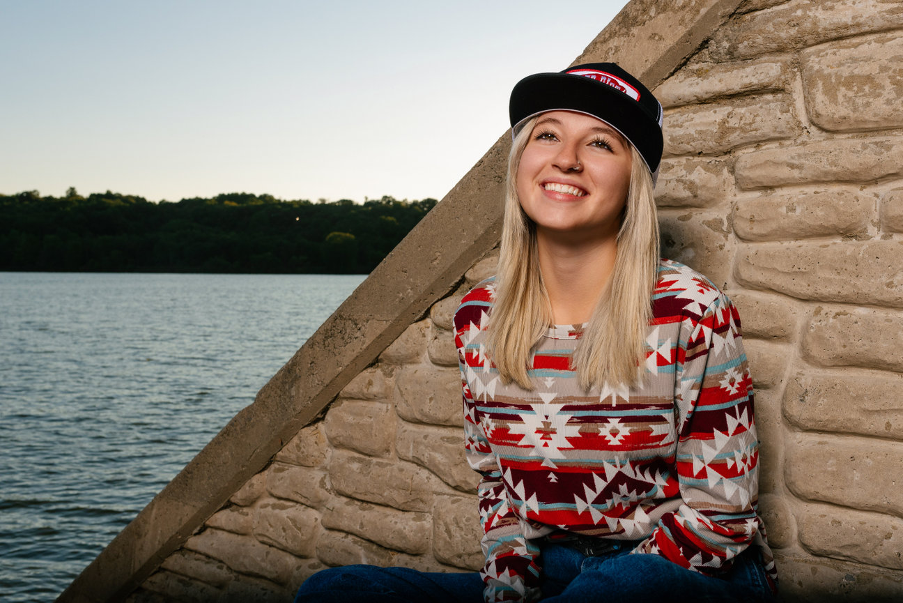 smiling senior at Lake Wilhelm in a country outfit