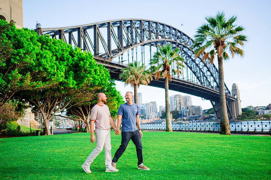 Couple walking in a park during a Sydney Opera House Photoshoot with Sarah Iris Photography.
