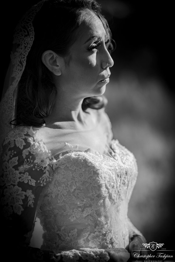 Black and white close-up of a bride in a lace dress