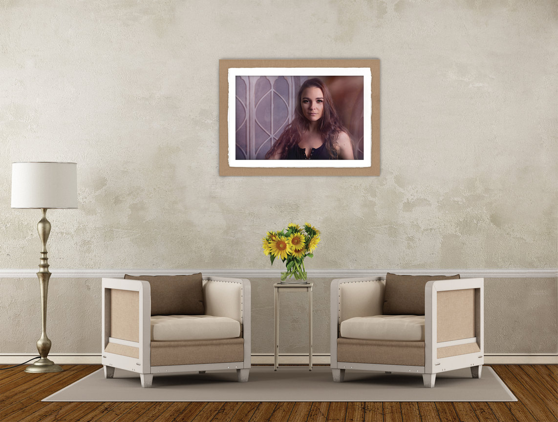 Statement wall art display in a refined living space, featuring a personal portrait print with a deckled edge mount, styled above seating to highlight a timeless, curated presentation.