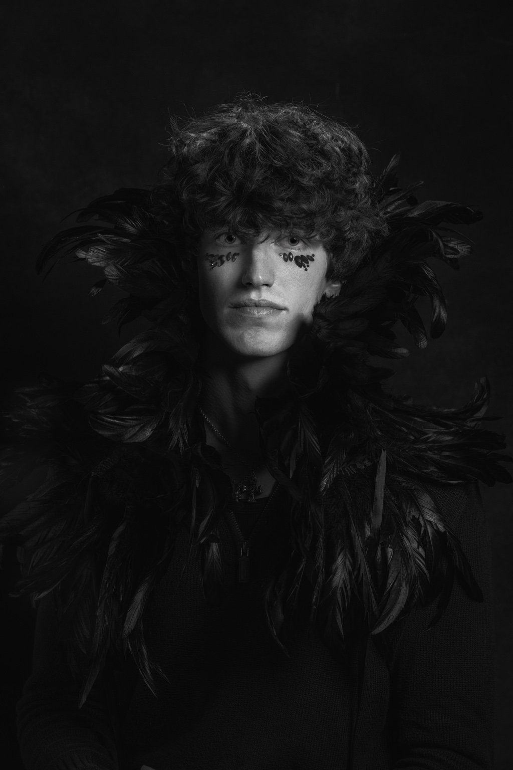Black and white portrait with a dramatic feather collar