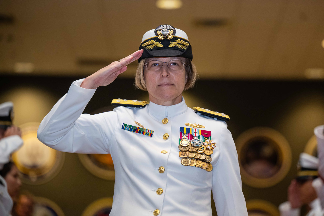 Navy Admiral saluting during her retirement ceremony photographed by Laura Hatcher Photography