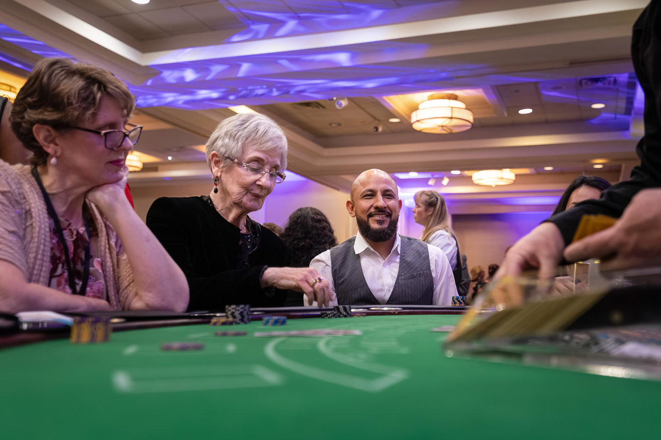 Candid event photography, professional event photographer, casino night themed event - red bow tie photography