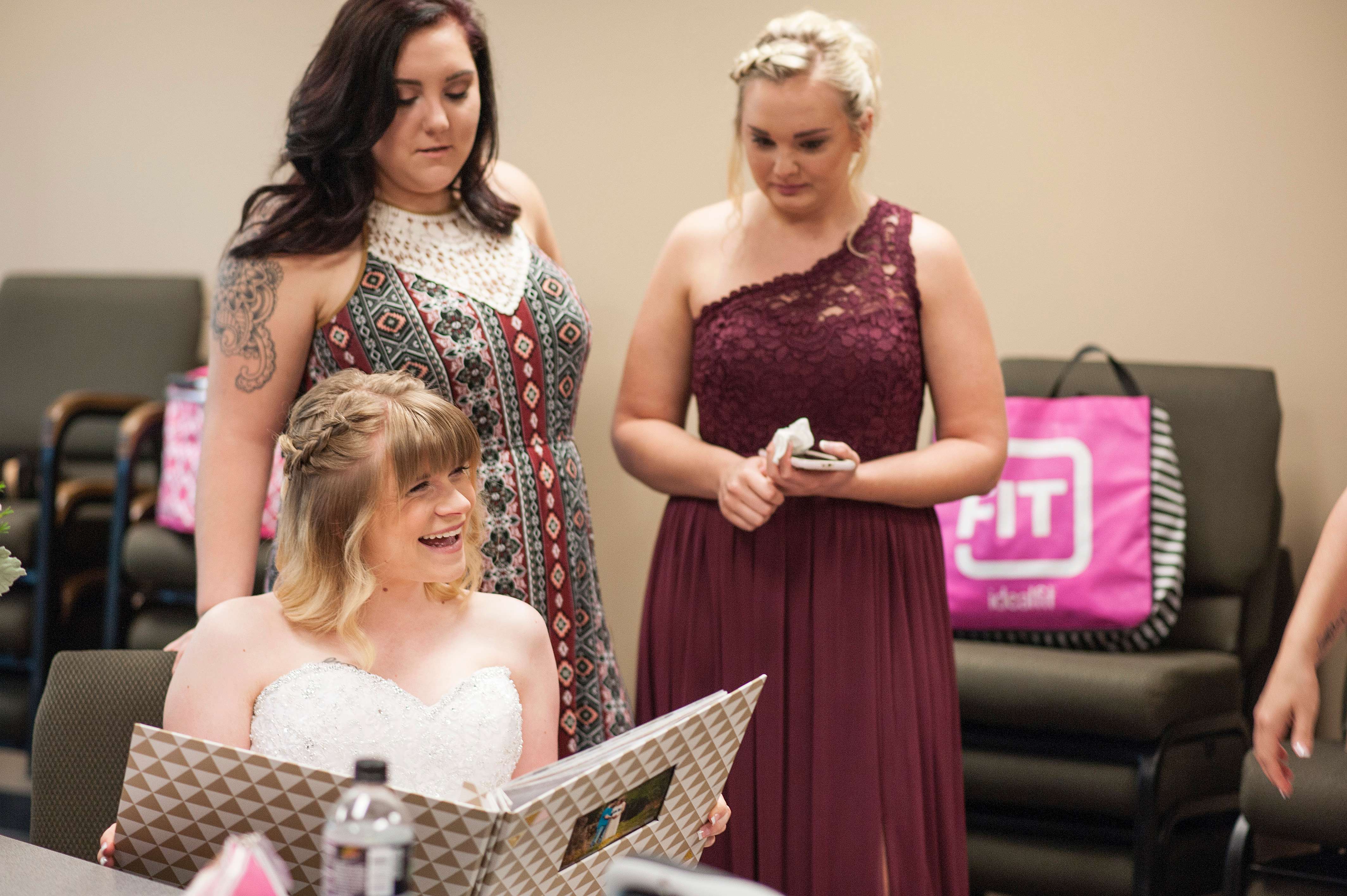 Bride laughing with bridesmaids.