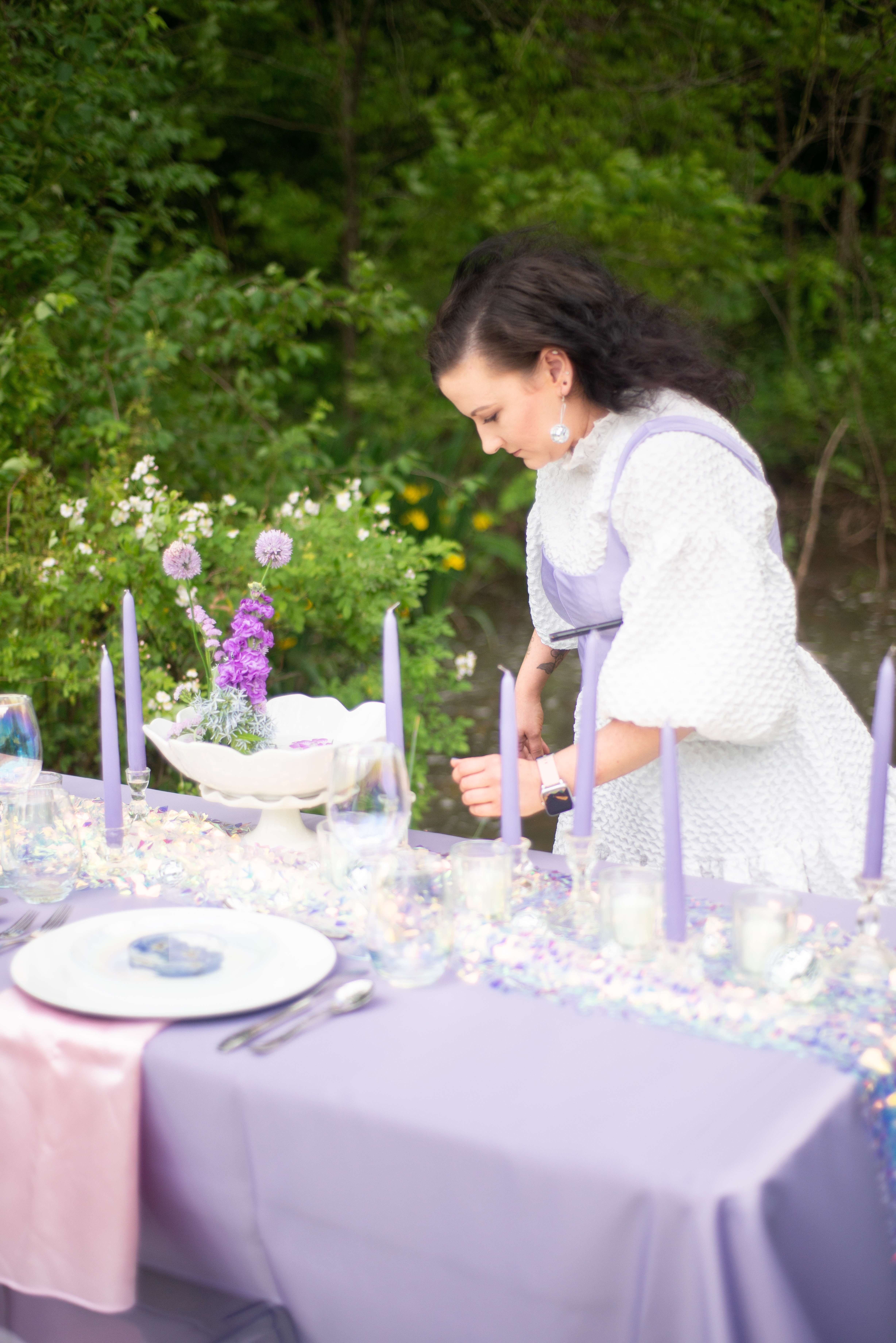 Wedding Planner Karissa McIntire setting a table at Enchanted Hills