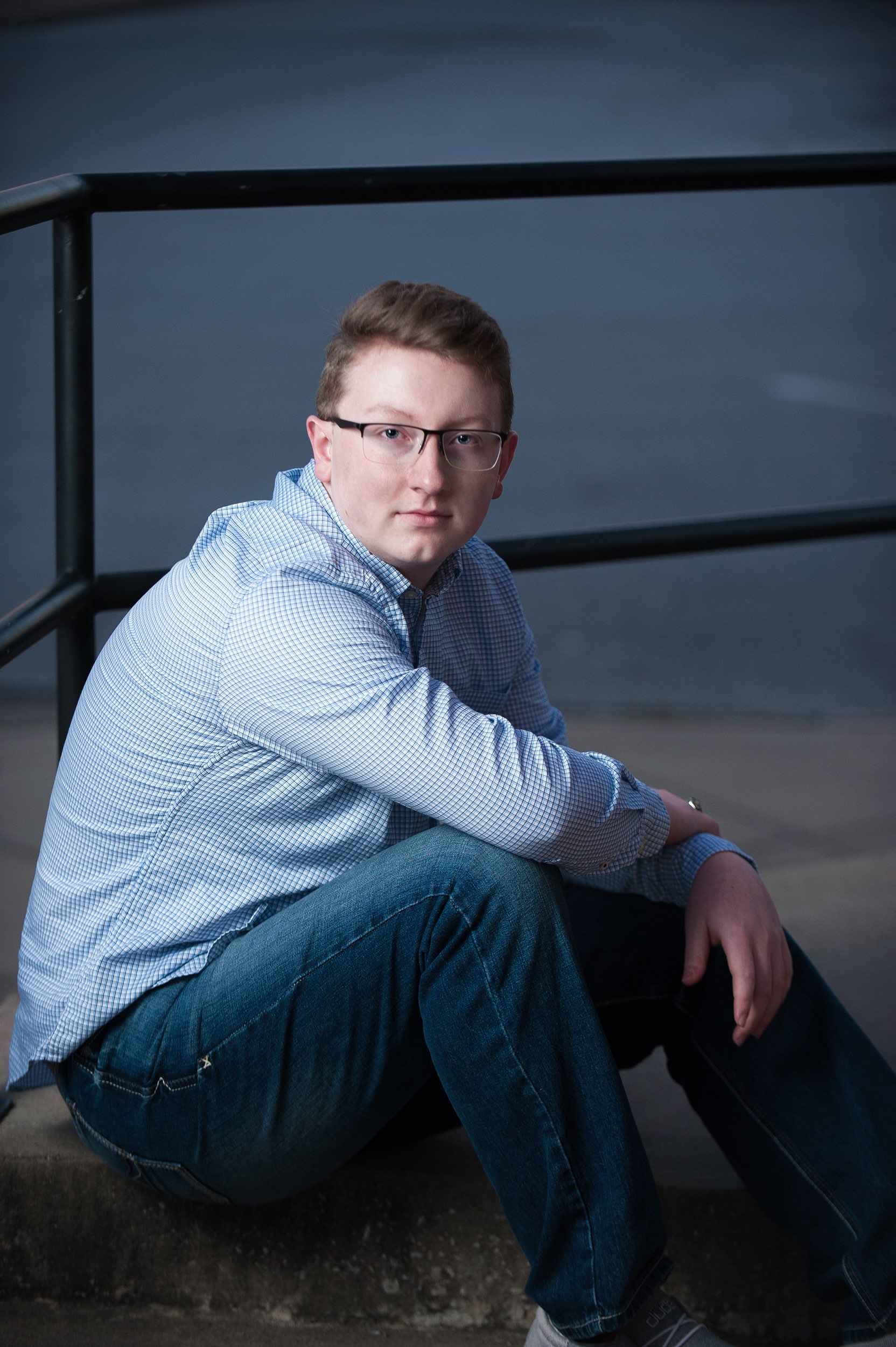 Senior guy sitting on steps at The Bean Counter in Galena, MO.