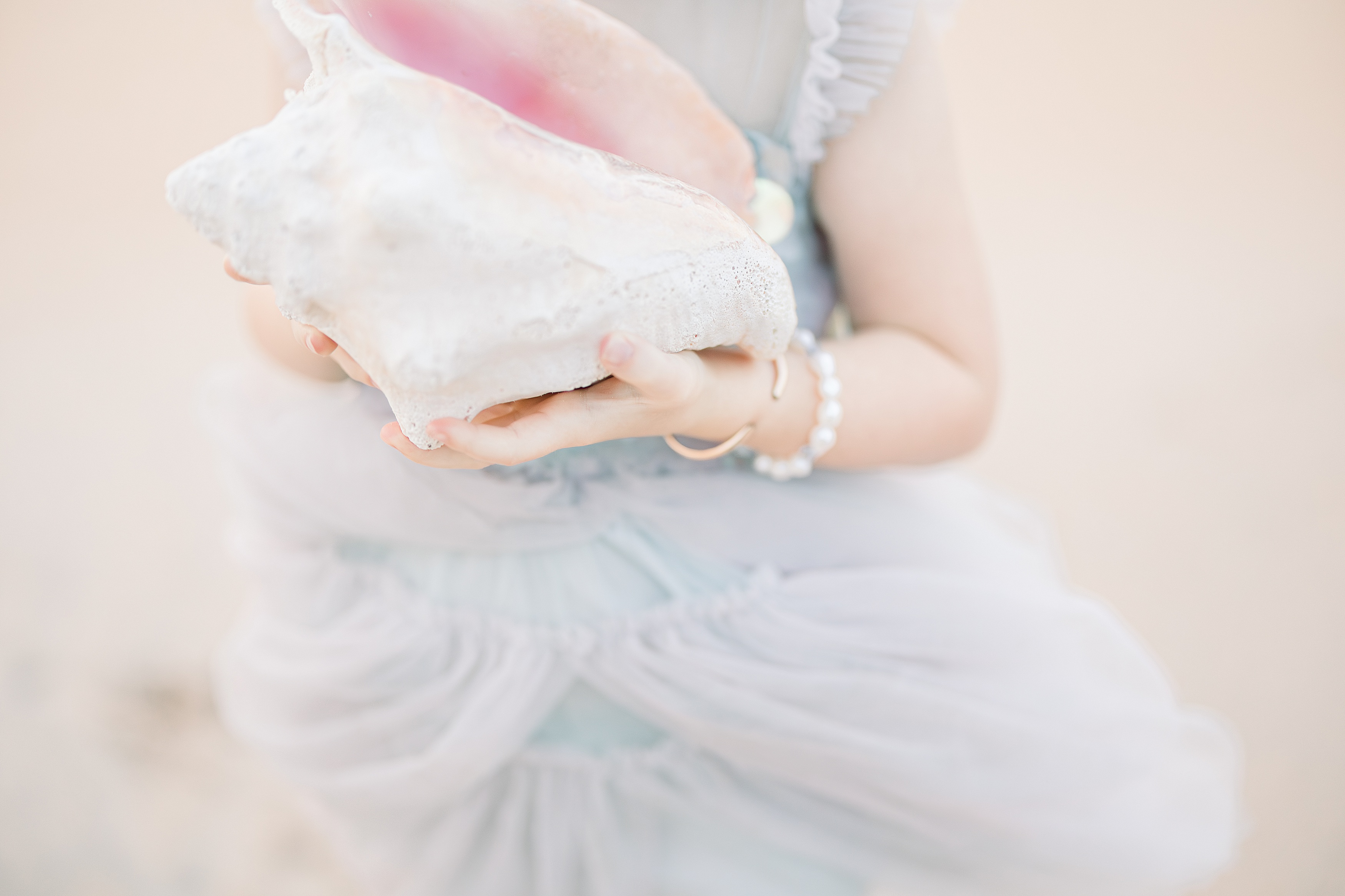 pastel conch shell image of a little girl at the beach