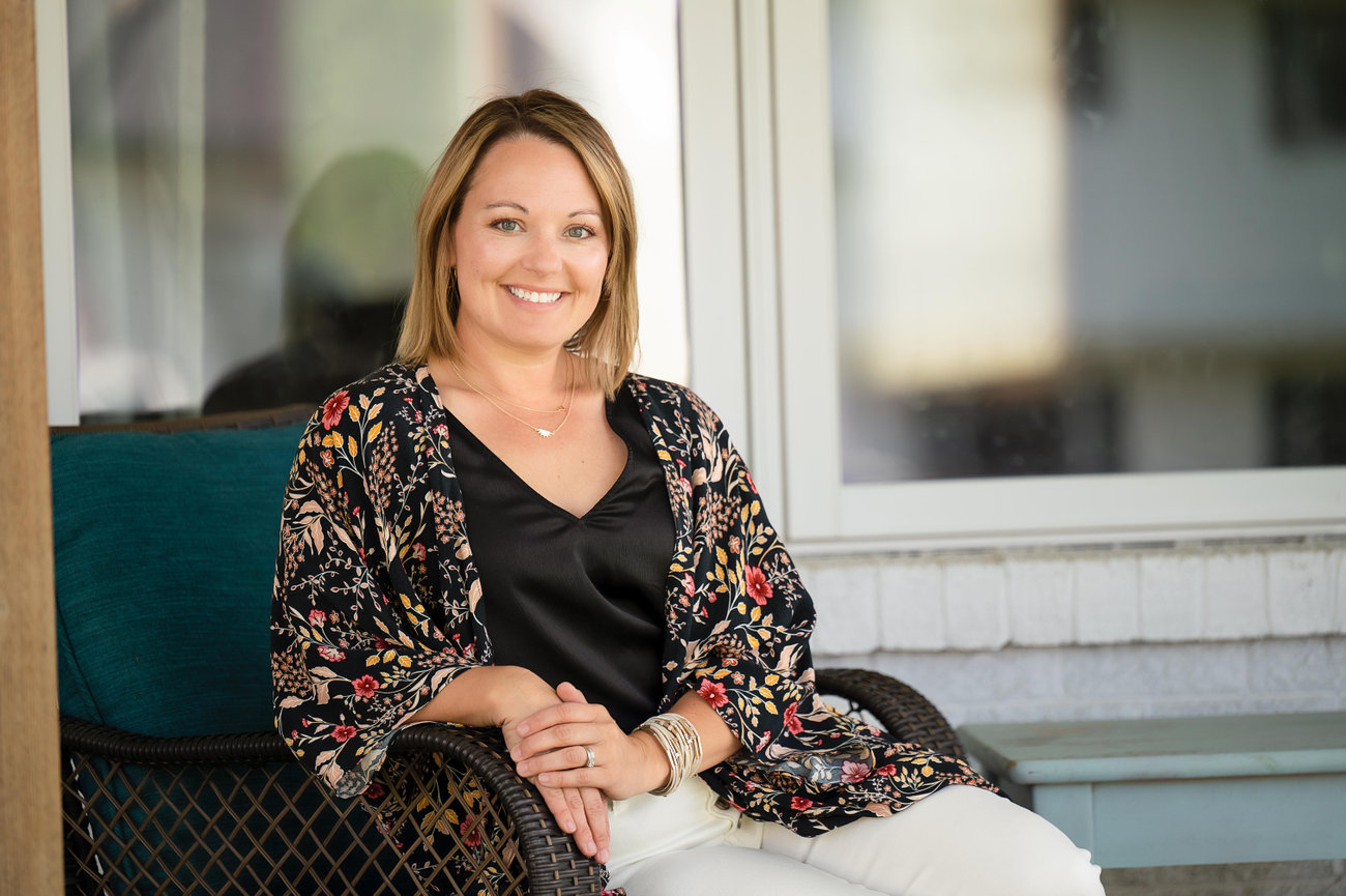 Insurance agent sitting on a home her company insures, branding photographer onalaska wi