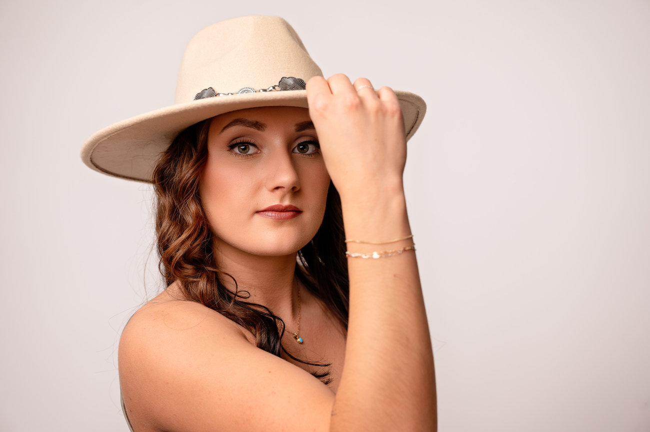 branding photographer la crosse wisconsin, business woman showing off her personality with a cowboy hat