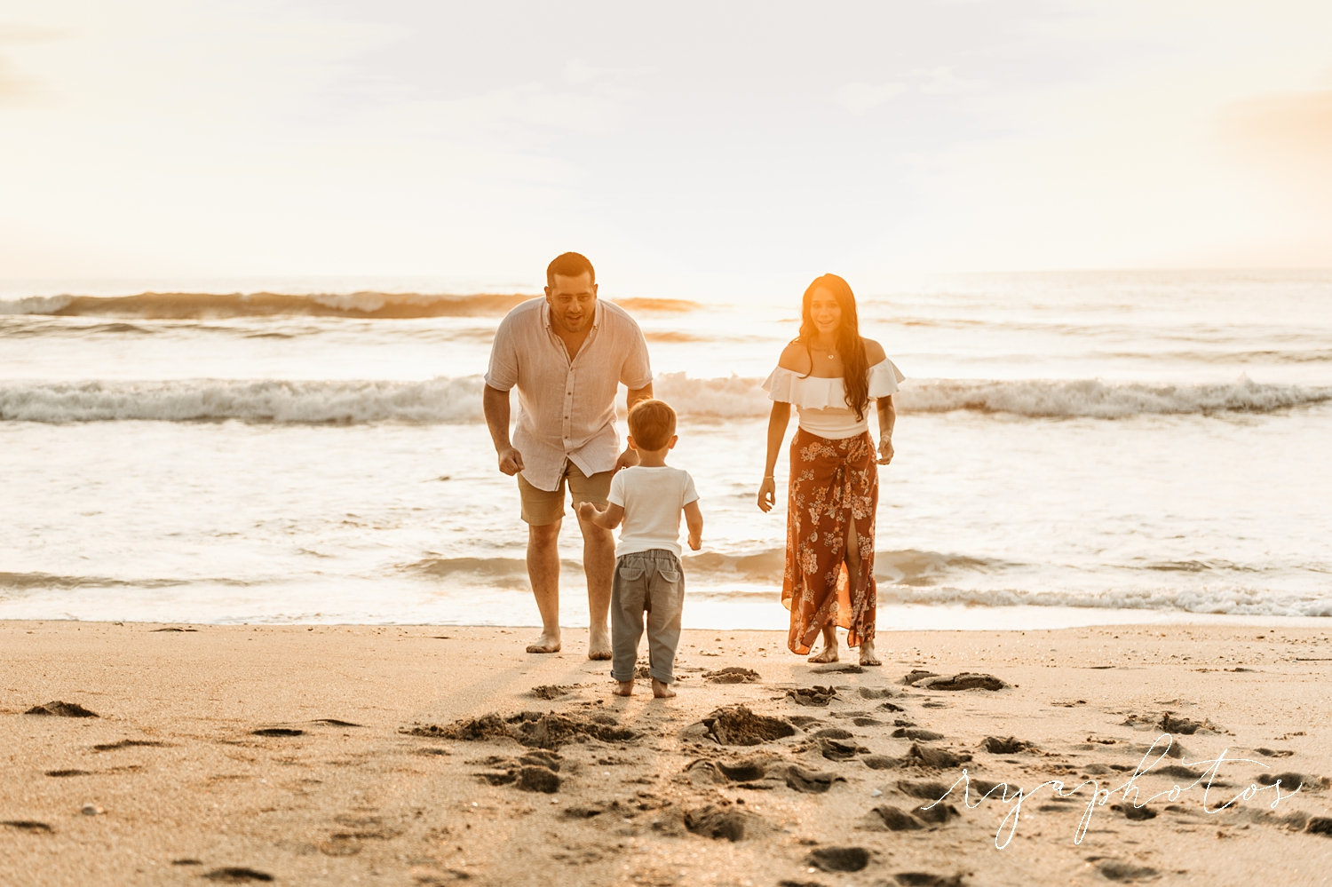 parents and toddler on a beach at sunrise, St. Augustine Beach, Ryaphotos