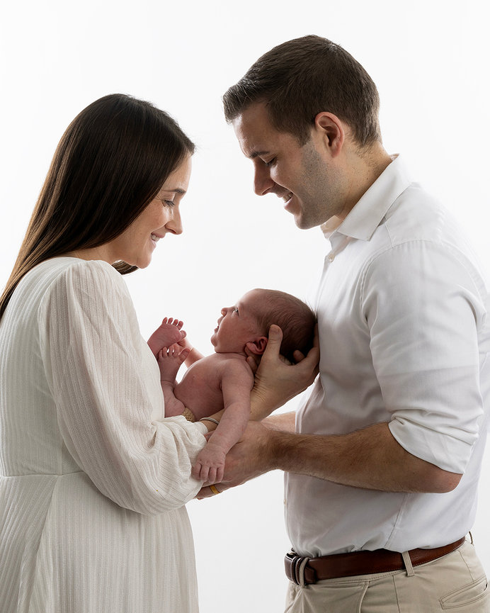 Parents gazing at their newborn baby