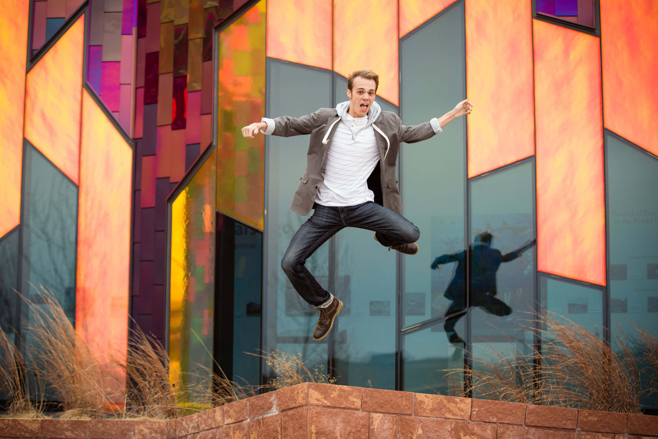Man jumping with a colorful building backdrop