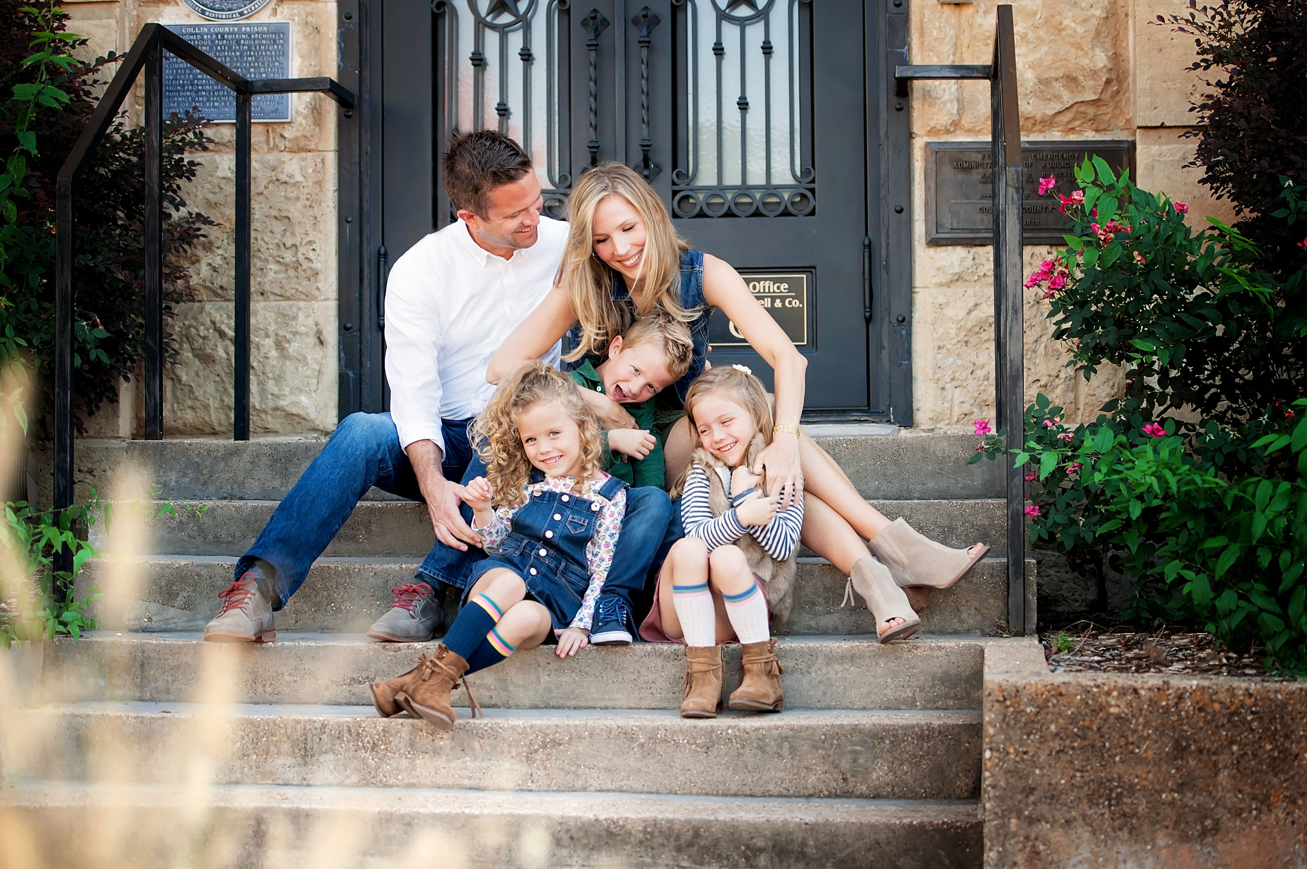 Family of five sitting on front steps for family photos