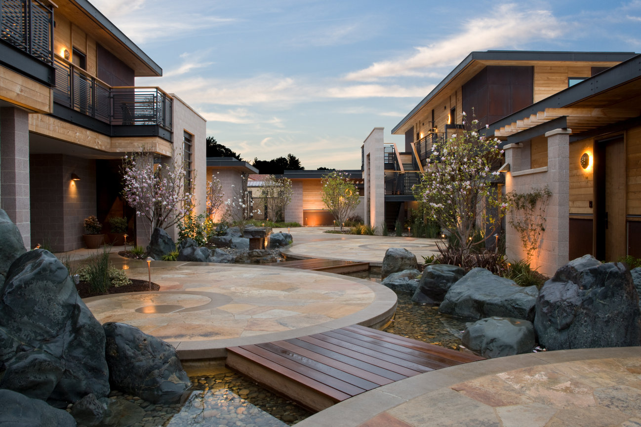 Bardessono Hotel Napa Valley Exterior with winding paths over man made streams which lead to the Hotel Guest rooms.