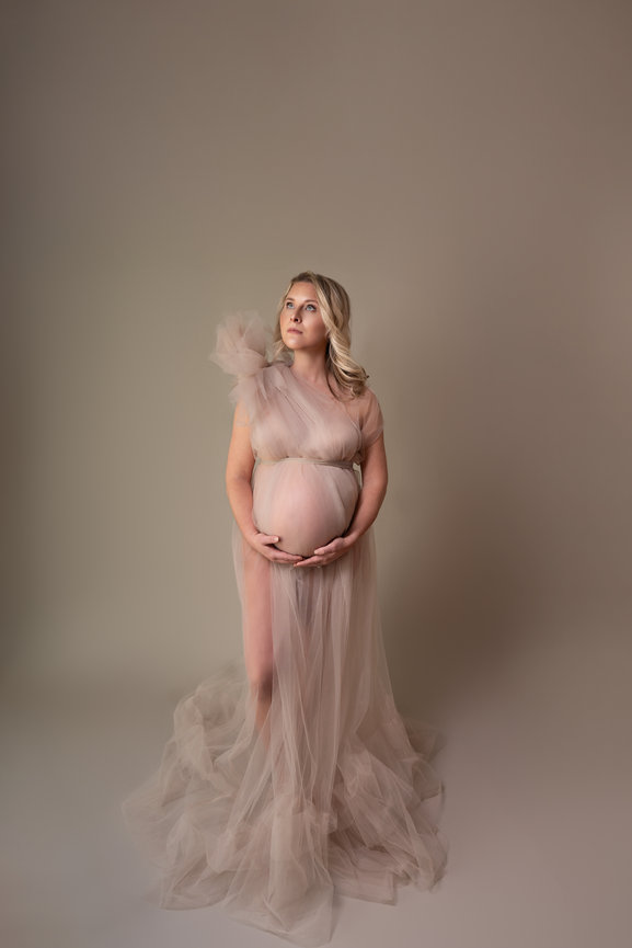 Minimalist maternity photo with standing pose and soft lighting, Holmdel NJ