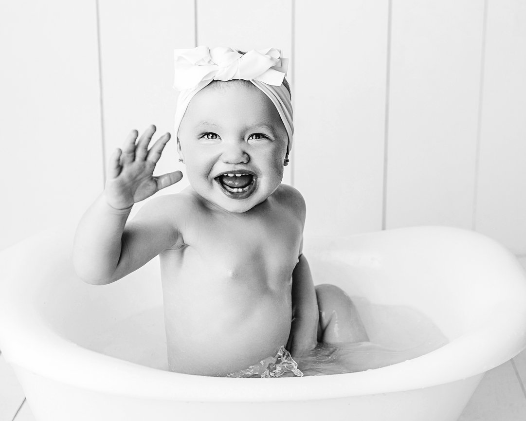 Point Pleasant studio features black and white photo of baby in bathtub after cake smash