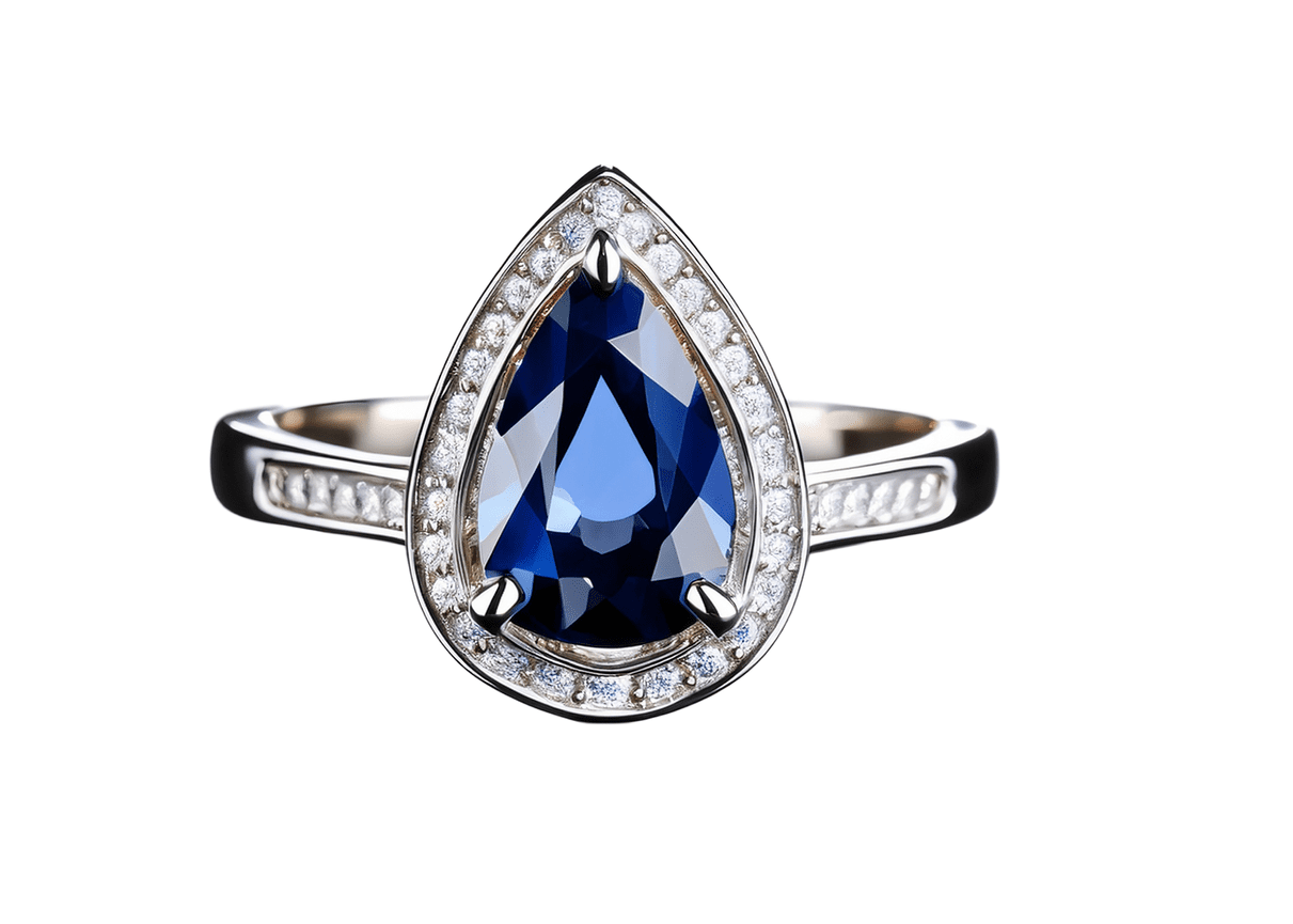 Elegant pear-shaped sapphire ring set in platinum, featuring a halo of small round diamonds surrounding the deep blue center stone, with diamond accents along the band, photographed on a white background