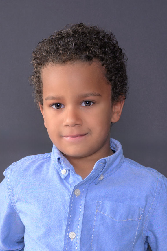 Young boy looking at the camera having his headshot done for a casting all portrait.