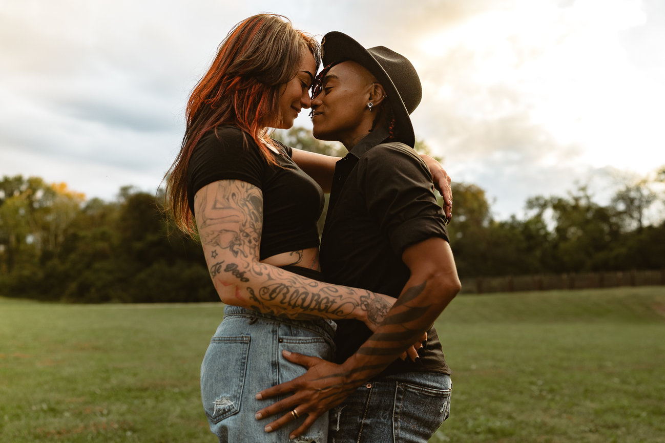 Couple sharing a kiss in a field
