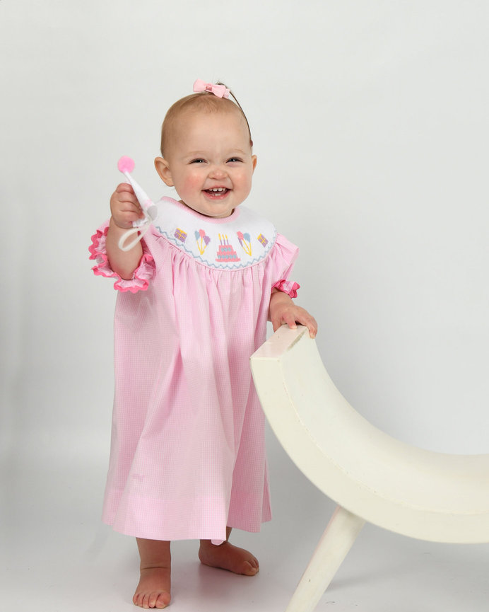 Smiling child in pink with a white goose