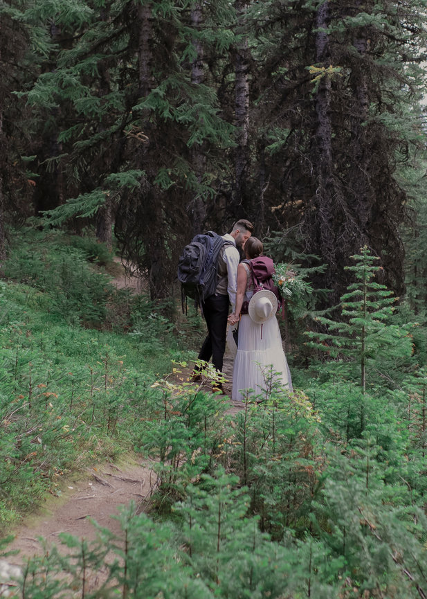 Couple walking through a dense forest