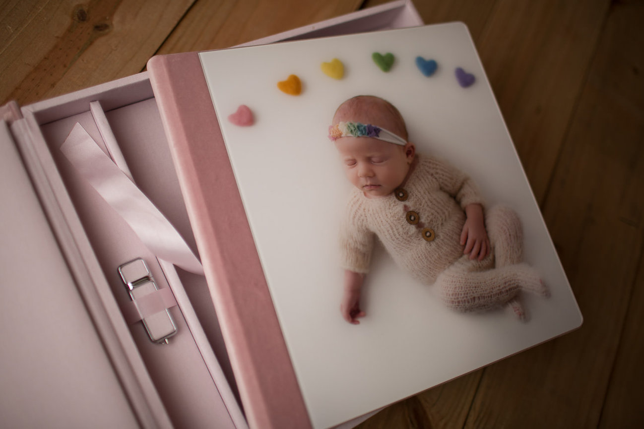 stunning photography album with velvet and acrylic front featuring picture of sleeping newborn by Kansas City newborn photographer Dreamworks Photography