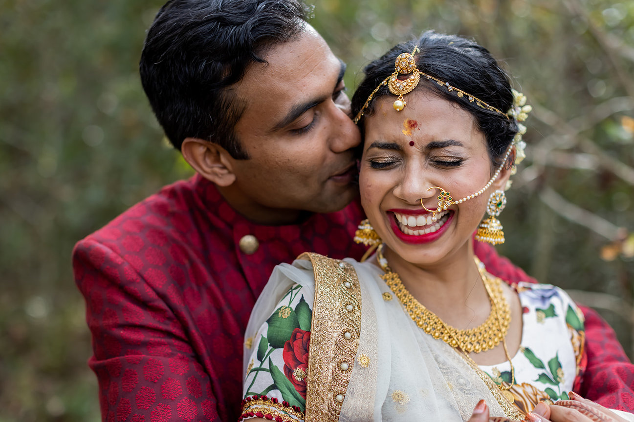 Happy couple in traditional wedding attire embracing