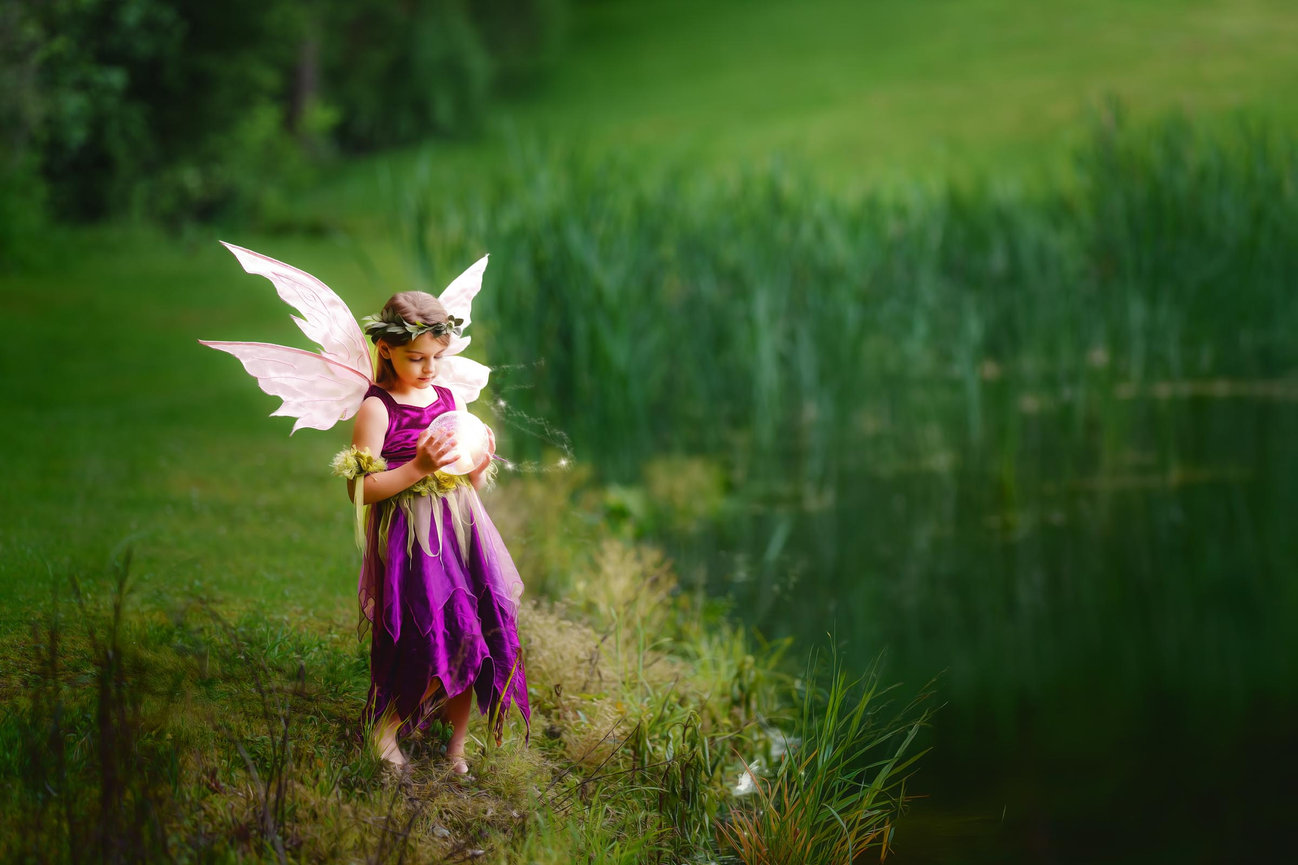 Young fairy in a flowing wine gown standing barefoot near a pond during a Fine Art outdoor portrait session near Cranberry Township