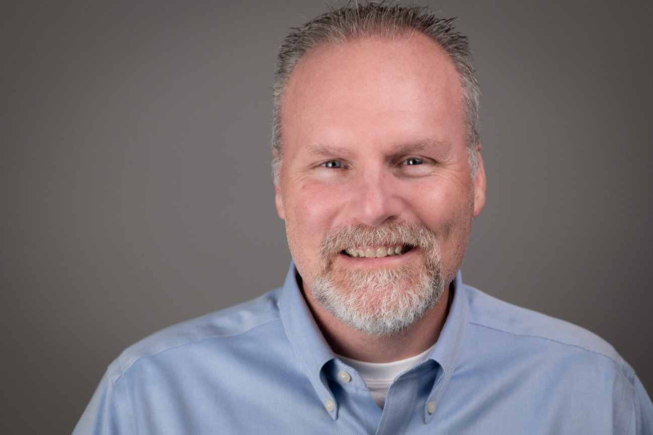 Smiling man in light blue shirt
