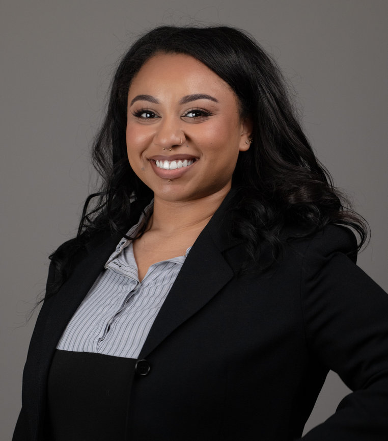 Woman in black suit smiling