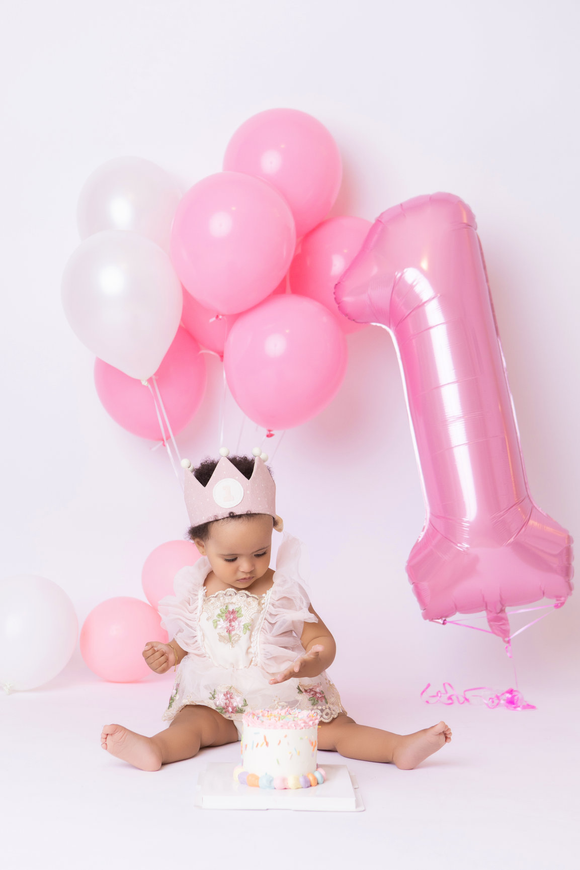 Calgary cake smash photography pink balloons tulle and bubbles first birthday session photo 16