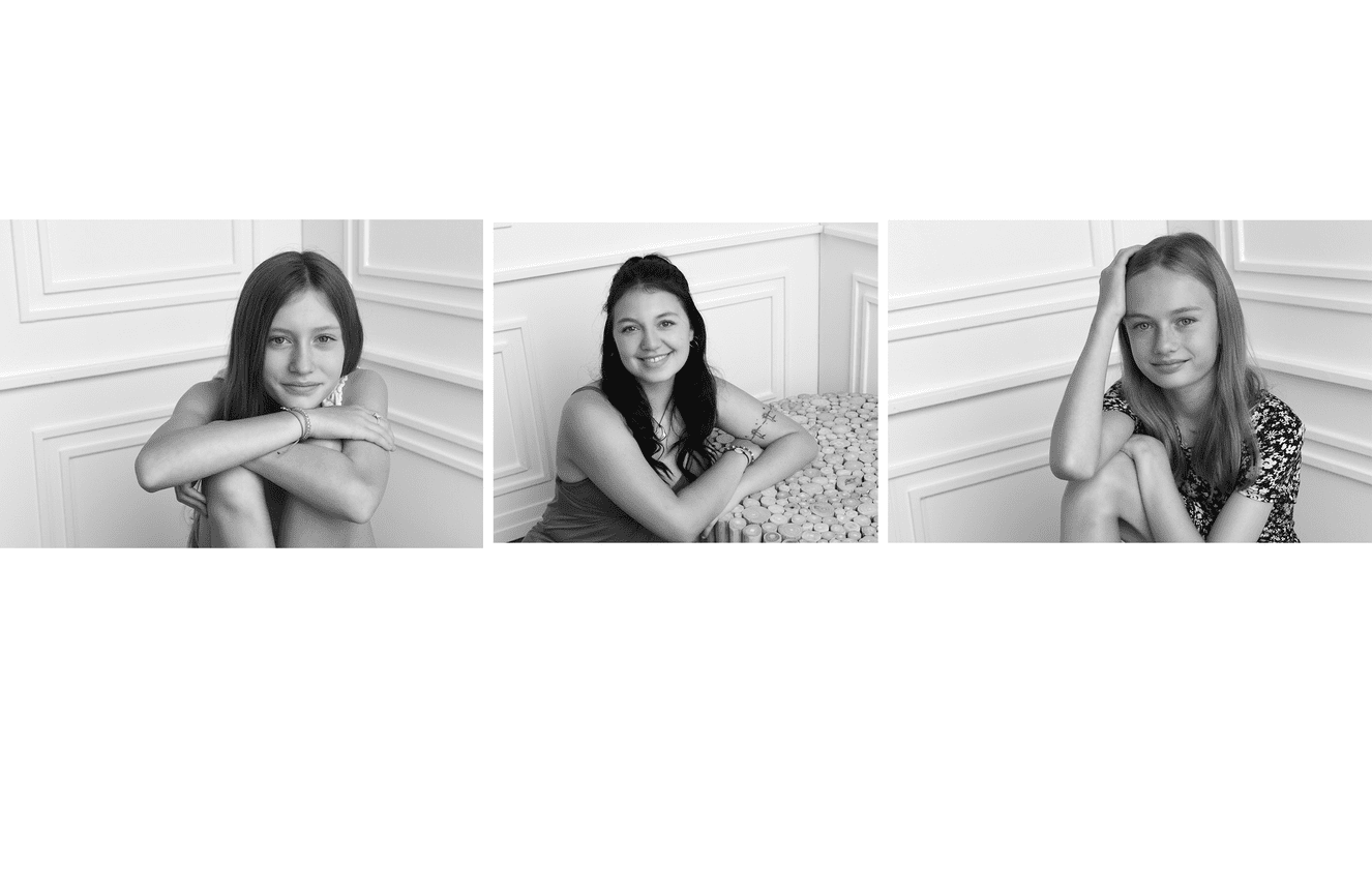 Close-up black and white headshots of three teenage sisters in summer dresses at Kliks Photography.