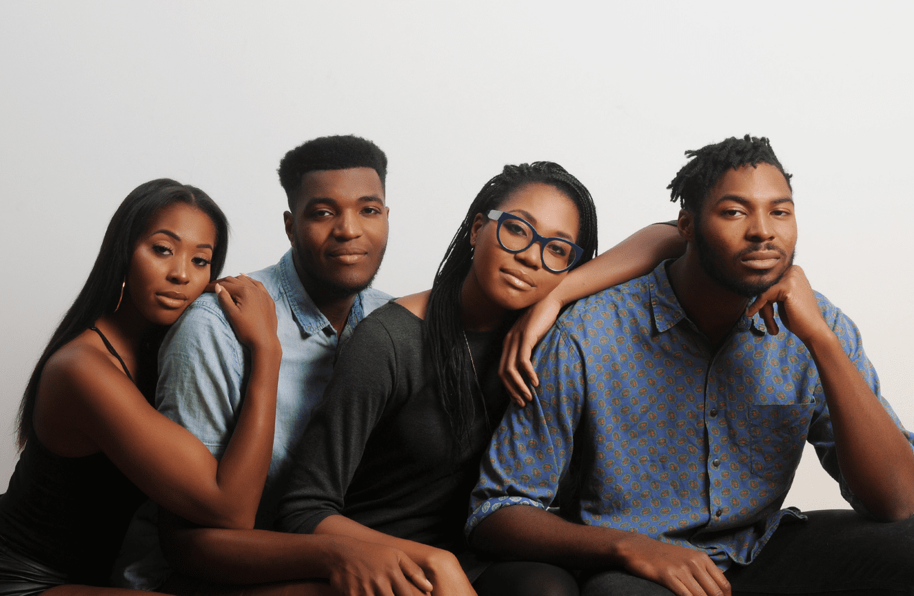 Two sisters and two brothers contently leaning on each other in comradery at Kliks Photography..