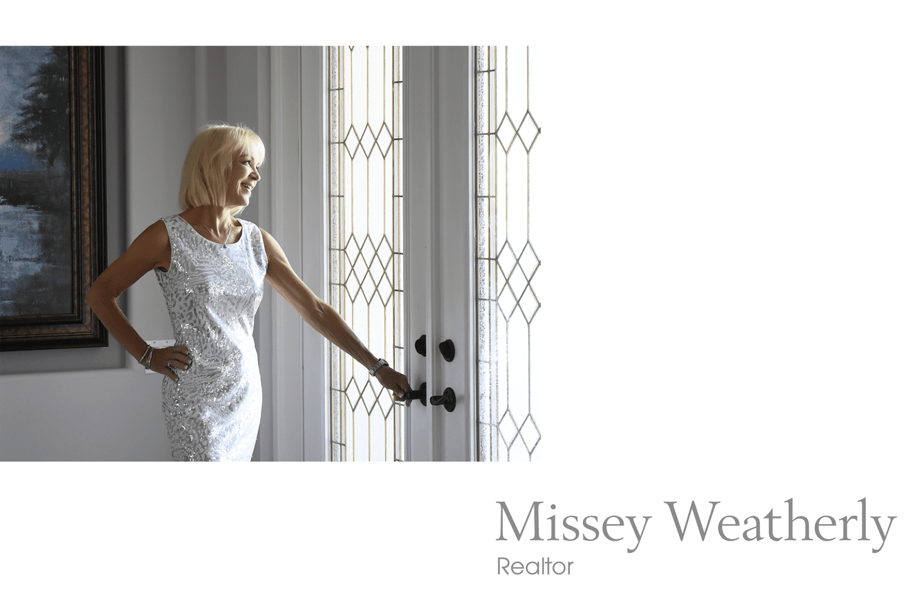 Realtor, Missey Weatherly, in a white dress stands at a stained glass door in Estero Florida..