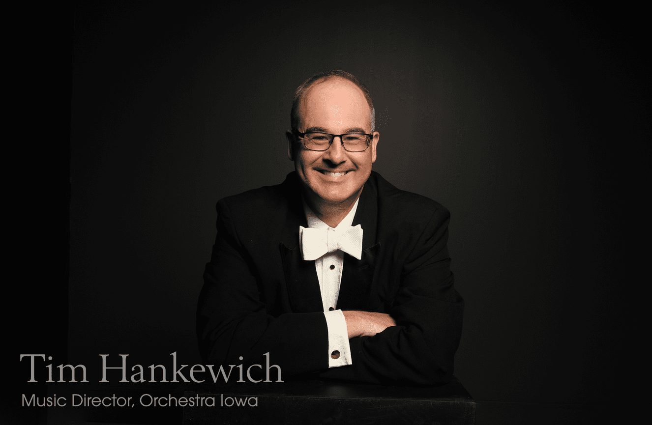 Orchestra Iowa music director, Tim Hankewich, smiles grandly in his white bow and black tux at Kliks Photography.